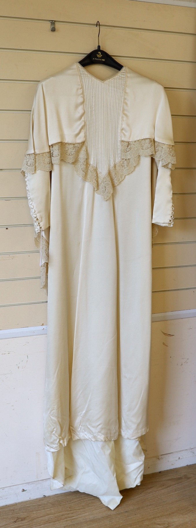 A 1970's cream satin wedding dress, trimmed with 19th century point de gaze, hand made needlepoint lace